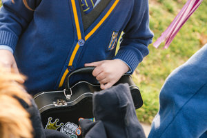 Schoolgirl with guitar lunchbox