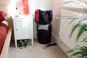 laundry bag in corner of bedroom