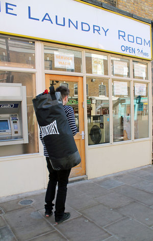 man taking laundry punch bags to cleaners