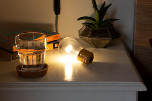 wireless light bulb lying on bedside table