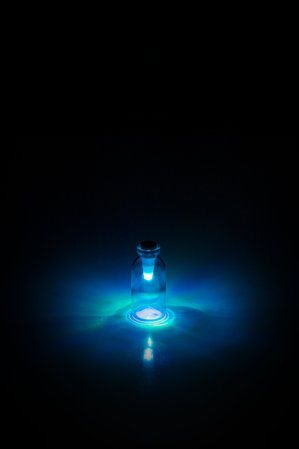 Multi-colour Bottle light by SuckUK - twist to select colour: Cyan light in glass bottle.