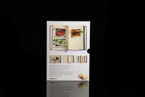 My Family Cookbook. Black hardback notebook with slip case packaging (back). Shown on black background.