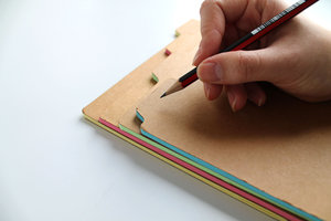 writing on notebook folder closeup