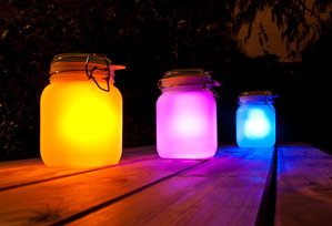 pink yellow blue sun jars on park table