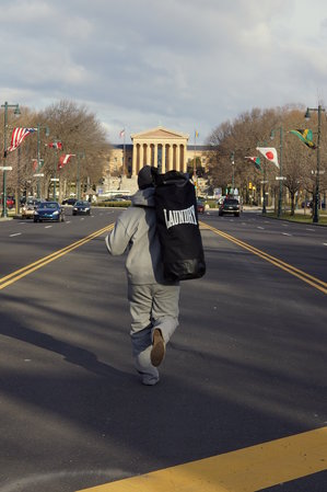 man running with rocky punching bags