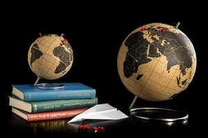 large and small travel globe with pins 